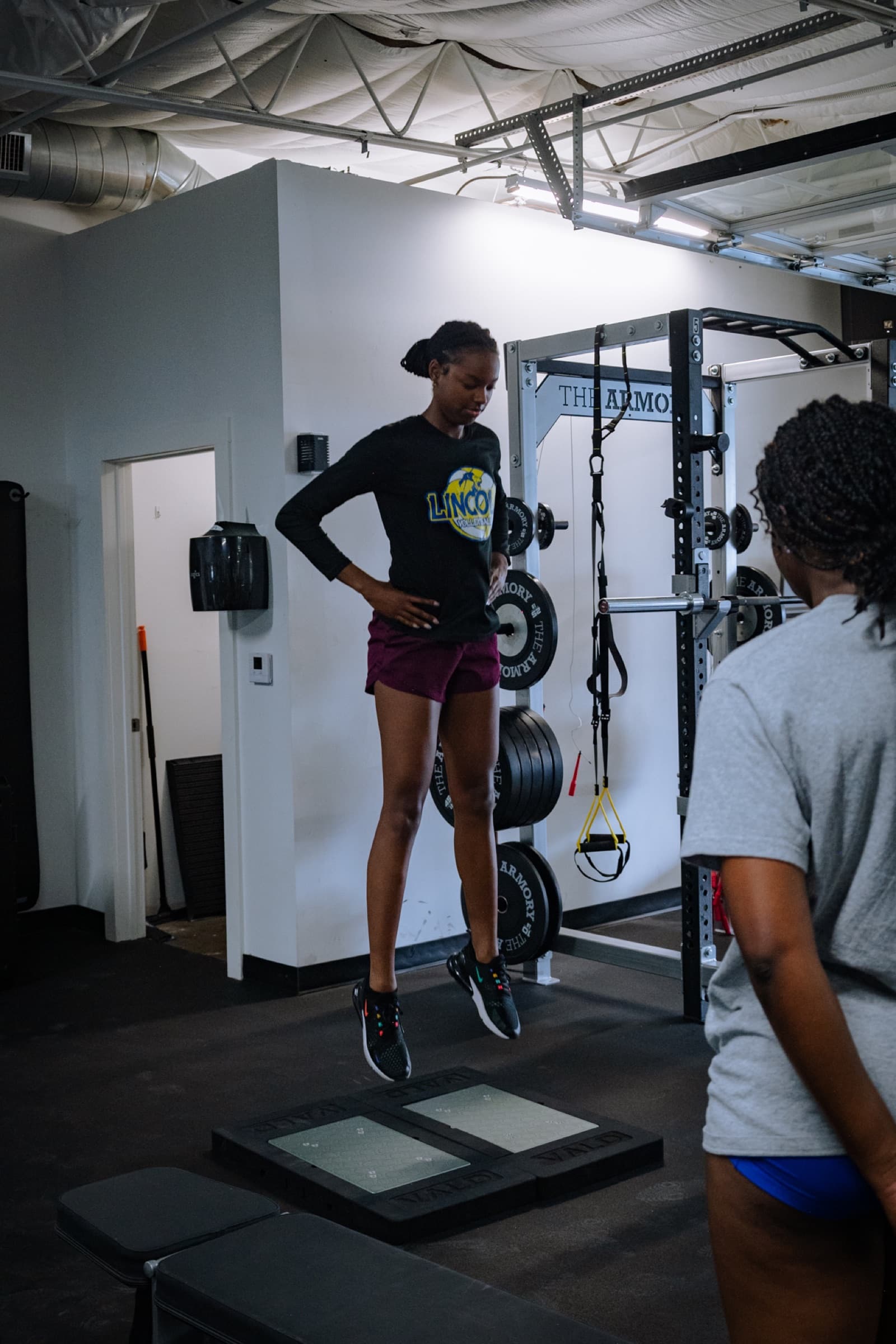 Athlete performing a countermovement jump on force plates at THE ARMORY